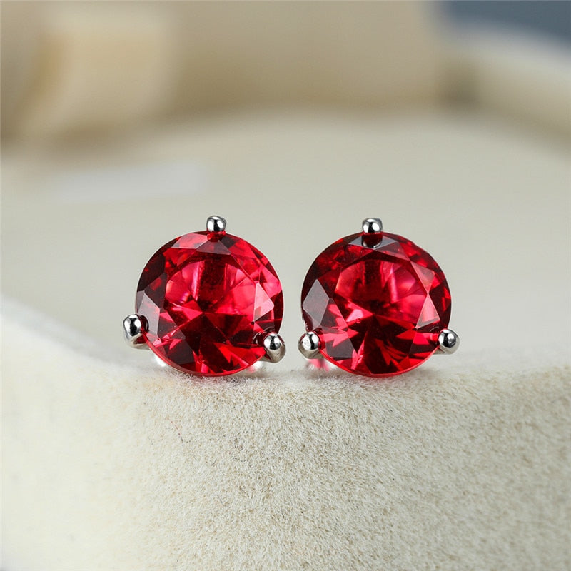 Round 3-claw earrings with red crystal zircons and screw closure